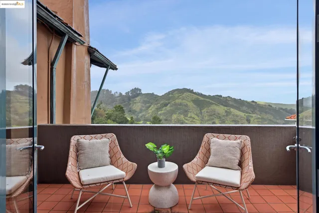 a living room with furniture a dining table and a large window