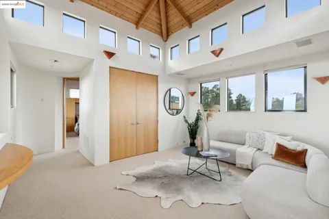 a bedroom with furniture and a large window