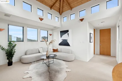 a view of a dry yard with mountains in the background
