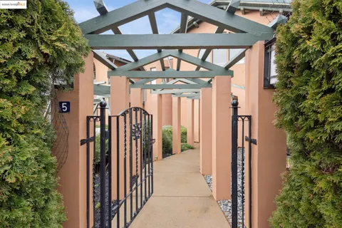 a view of a house with a small yard and floor to ceiling window