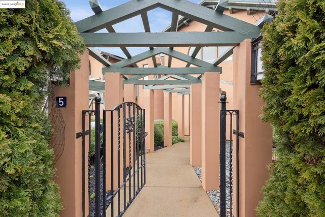 a view of a house with a small yard and floor to ceiling window