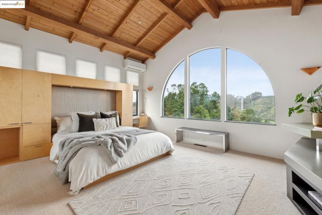 a bedroom with a bed and a large window