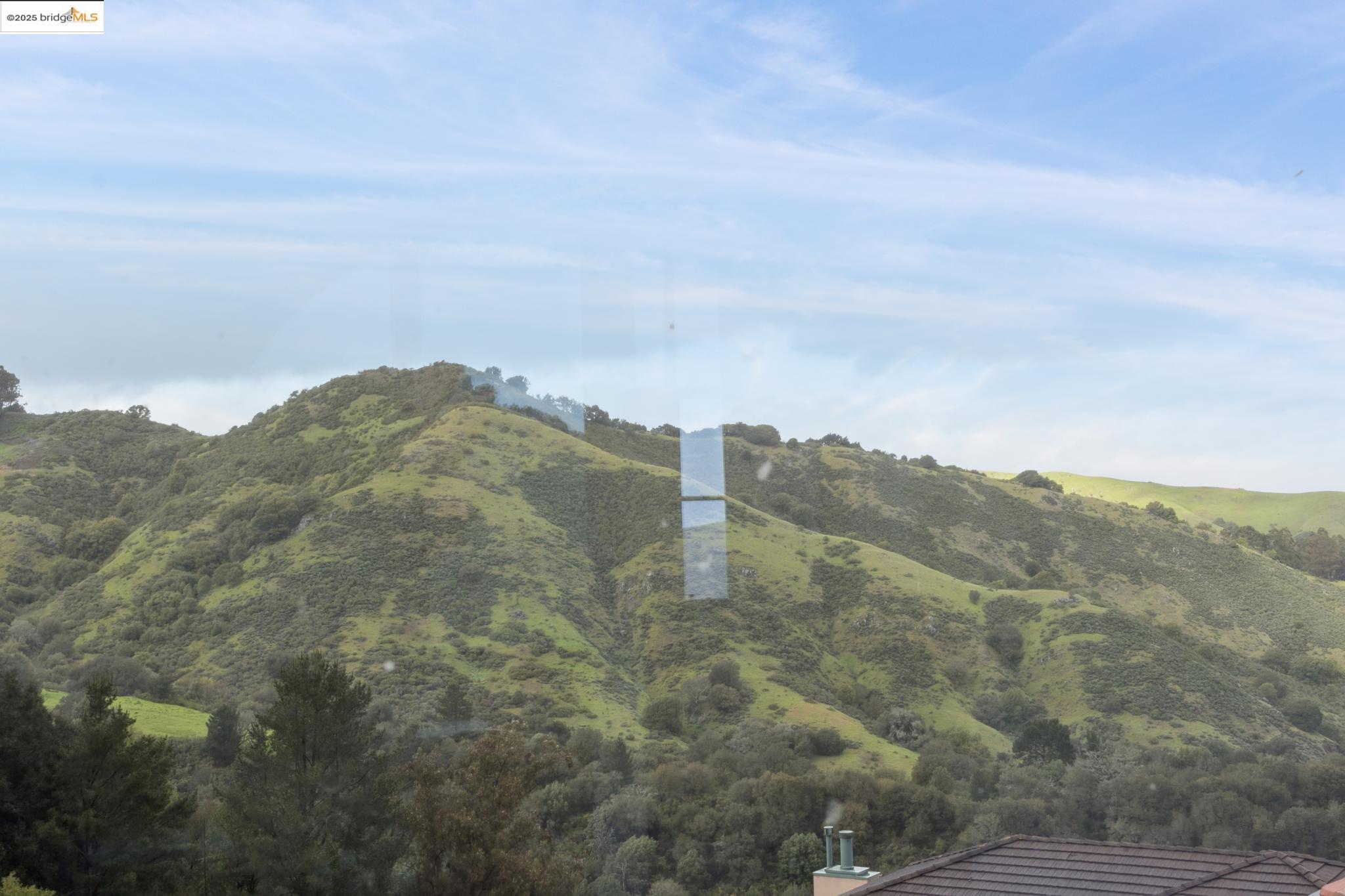 5 Woodside Way Oakland, CA 94611 - Photo 33 of 59 a view of a dry yard with mountains in the background