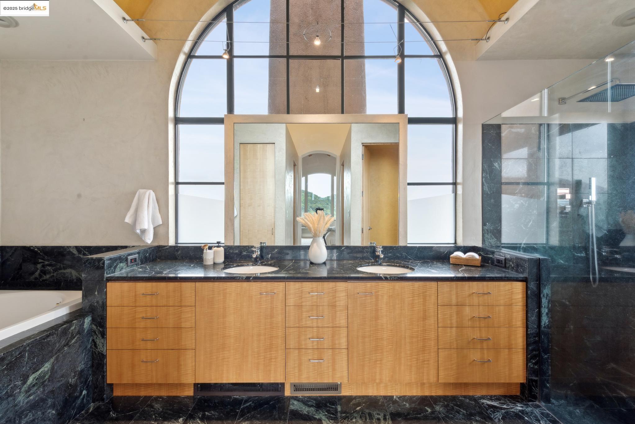 5 Woodside Way Oakland, CA 94611 - Photo 35 of 59 a bathroom with a granite countertop sink and a mirror