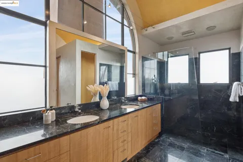 a bedroom with a large bed and a window