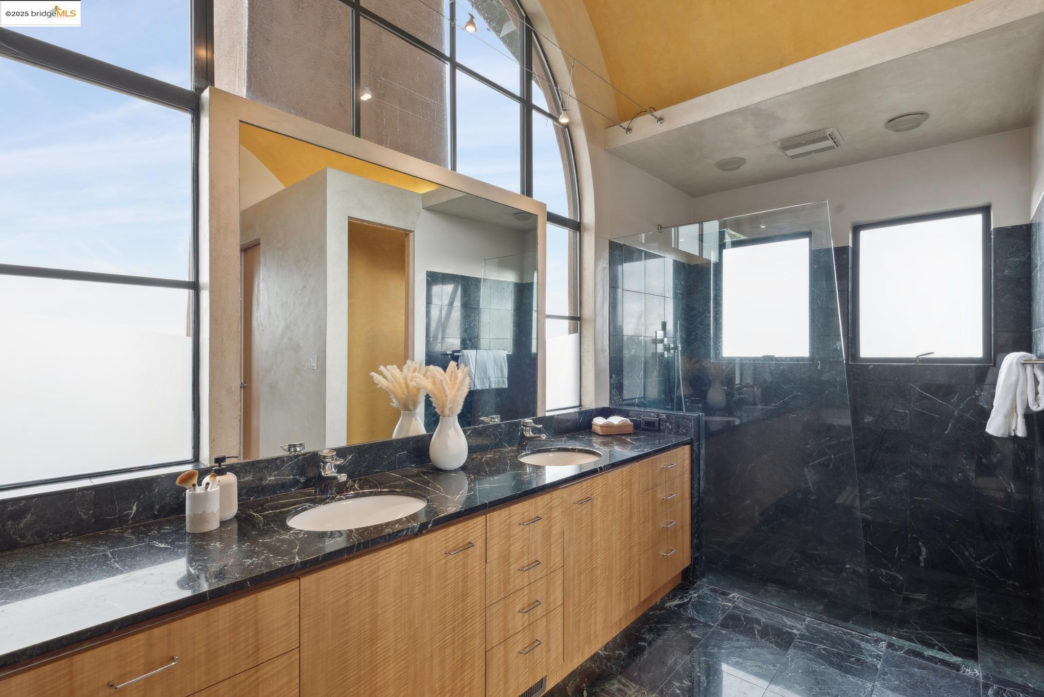 5 Woodside Way Oakland, CA 94611 - Photo 37 of 59 a bathroom with sinks mirror and shower