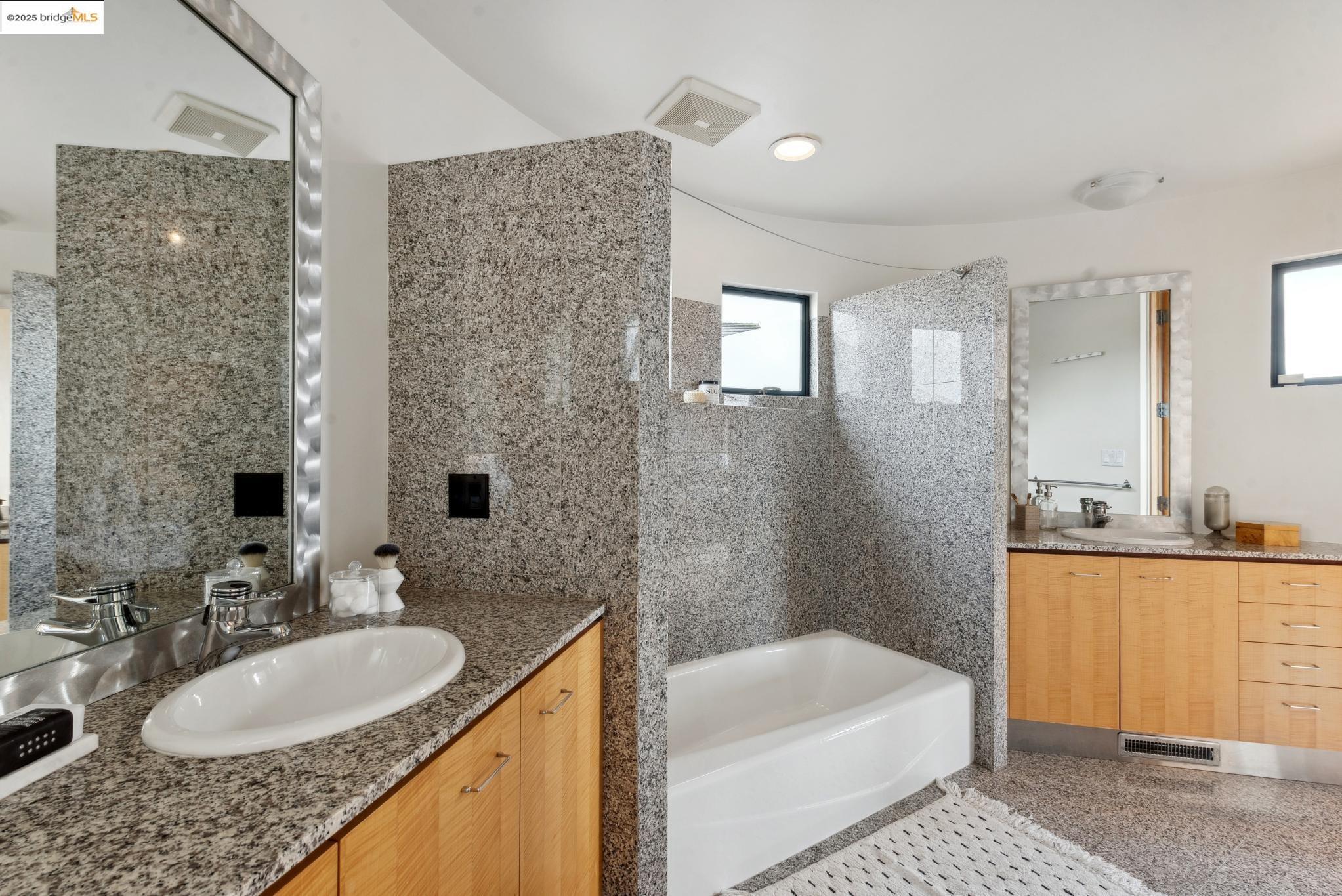 5 Woodside Way Oakland, CA 94611 - Photo 40 of 59 a bathroom with a granite countertop tub sink and mirror
