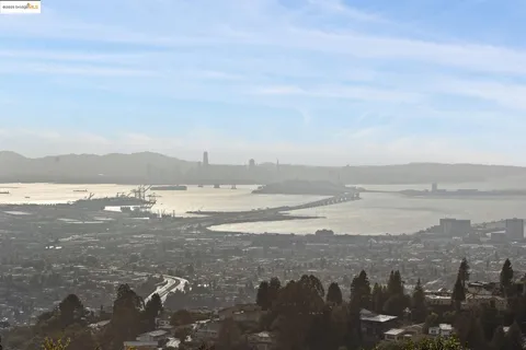 a spacious bedroom with a bed and glass door