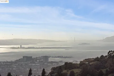 a spacious bedroom with a bed and a couch next to a window