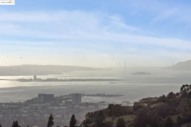 a spacious bedroom with a bed and a couch next to a window