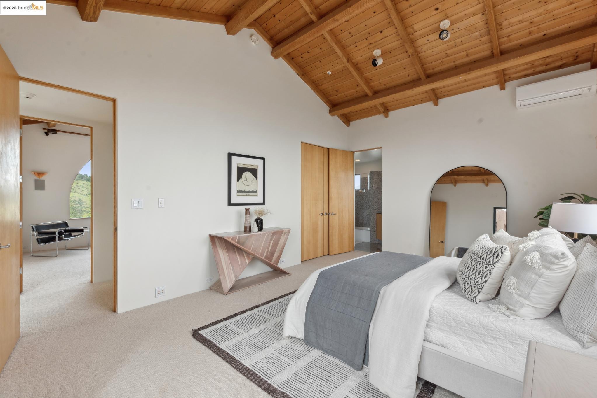 5 Woodside Way Oakland, CA 94611 - Photo 45 of 59 a bedroom with a bed and a chandelier