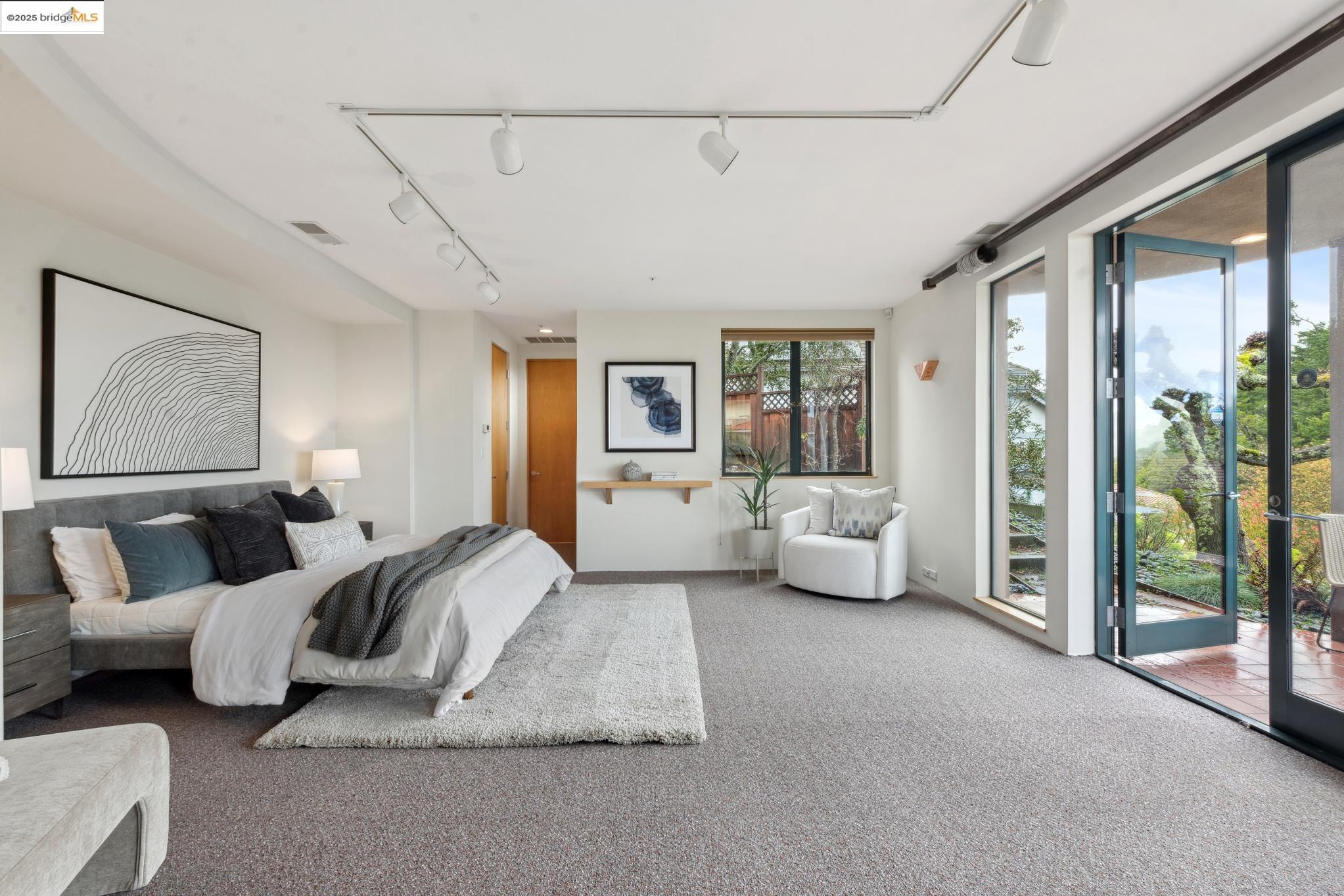 5 Woodside Way Oakland, CA 94611 - Photo 46 of 59 a spacious bedroom with a bed and glass door