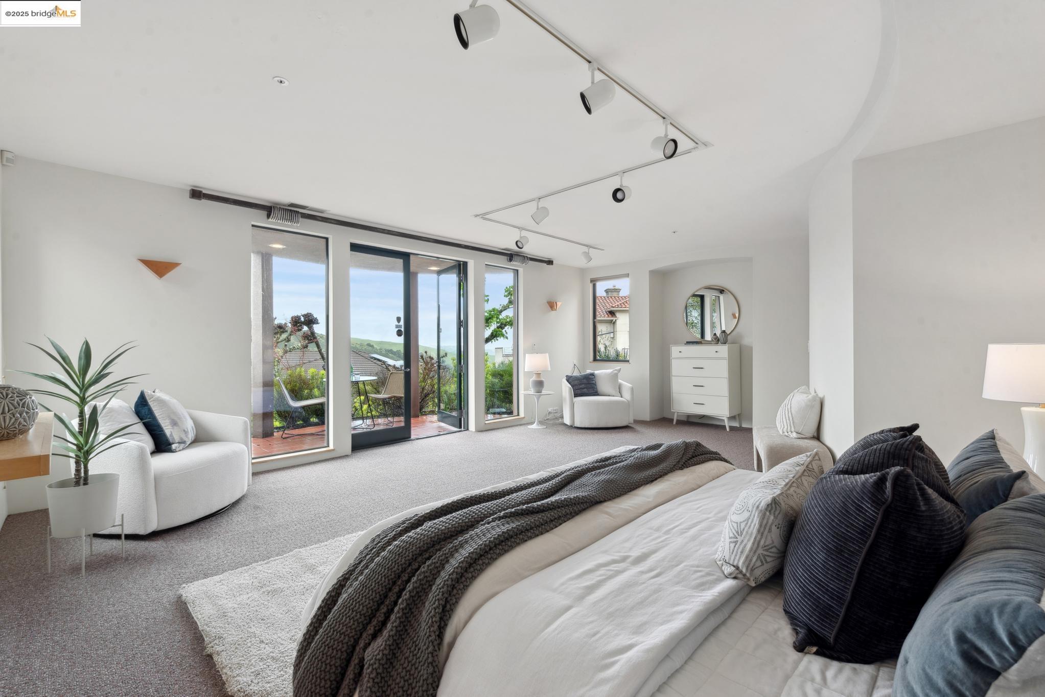 5 Woodside Way Oakland, CA 94611 - Photo 48 of 59 a spacious bedroom with a bed and glass window