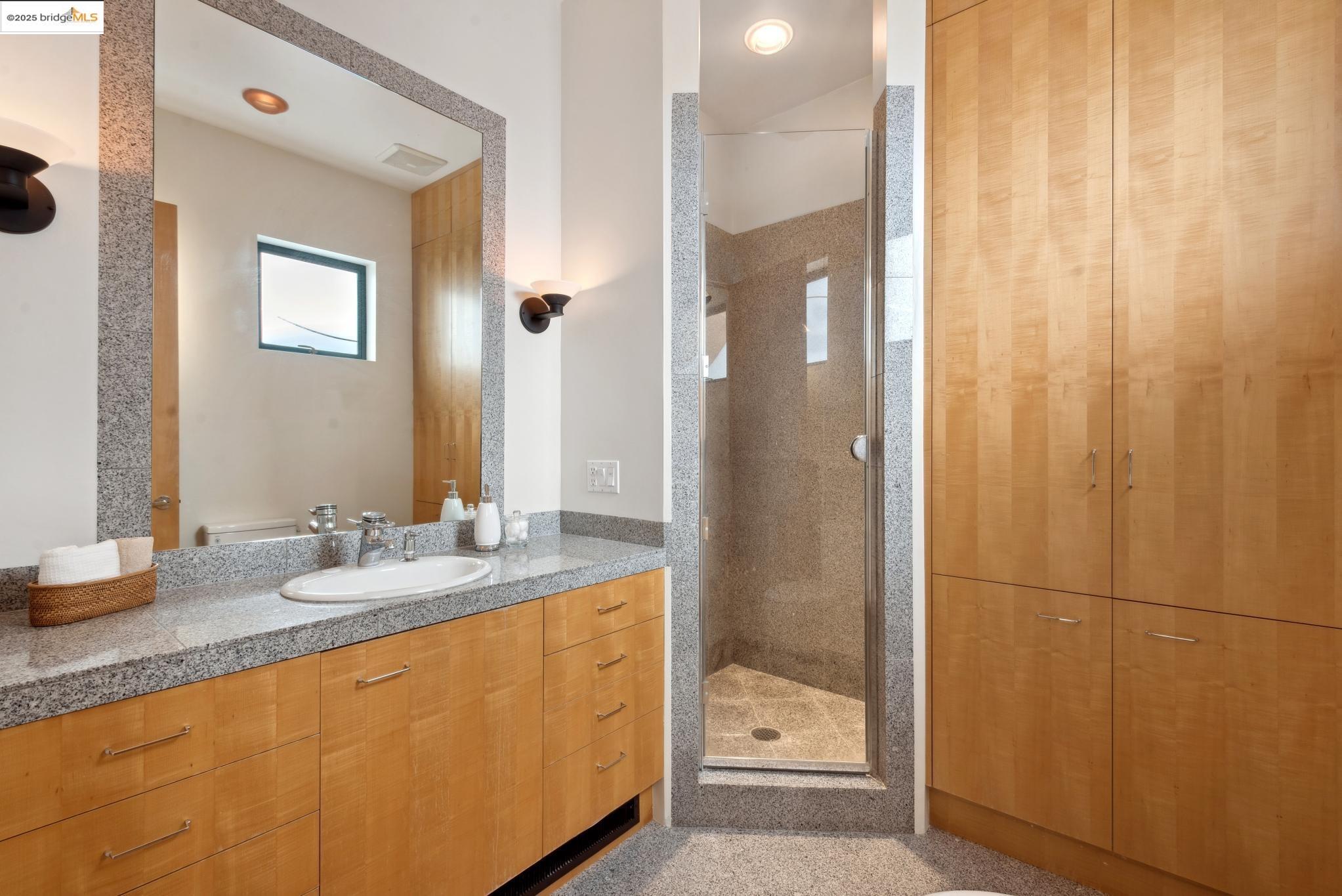 5 Woodside Way Oakland, CA 94611 - Photo 50 of 59 a bathroom with a granite countertop sink and a mirror