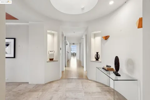 a view of a dining hall with couches and chandelier