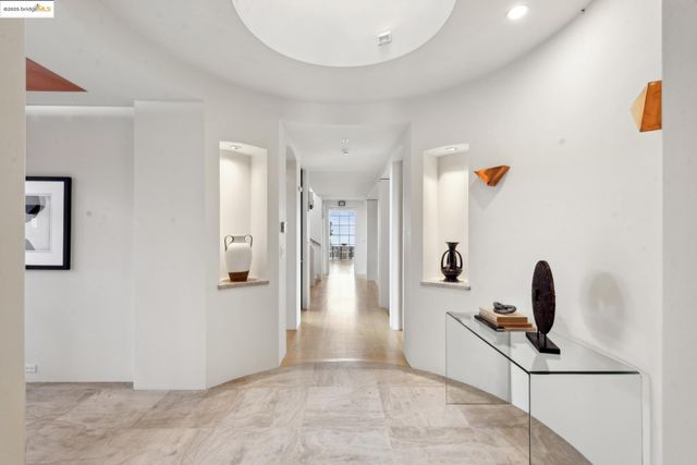 a view of a dining hall with couches and chandelier
