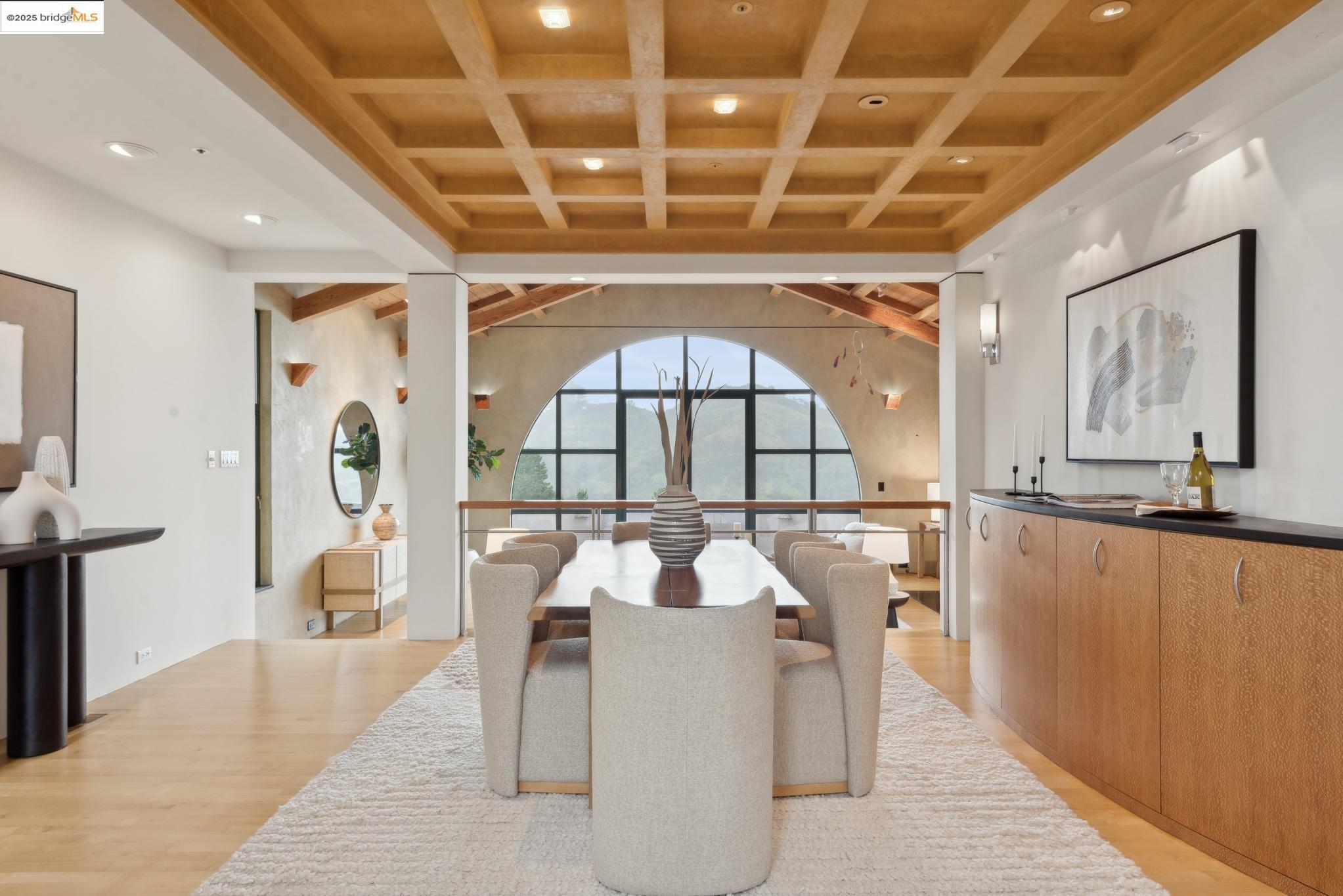 5 Woodside Way Oakland, CA 94611 - Photo 8 of 59 a dining room with wooden floor a chandelier a wooden table and chairs