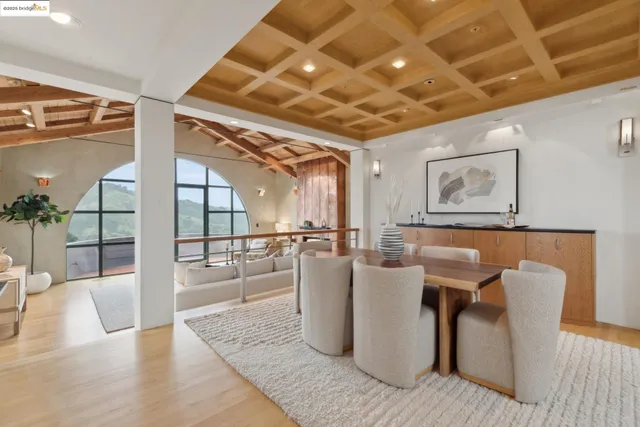 a living room with furniture a fireplace and a chandelier