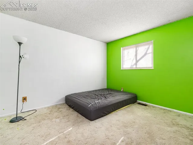 a bedroom with a bed and a plant