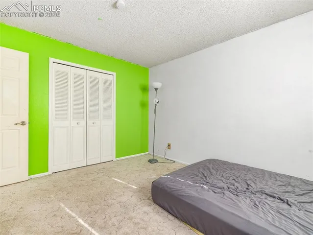 a bedroom with a bed and a mirror