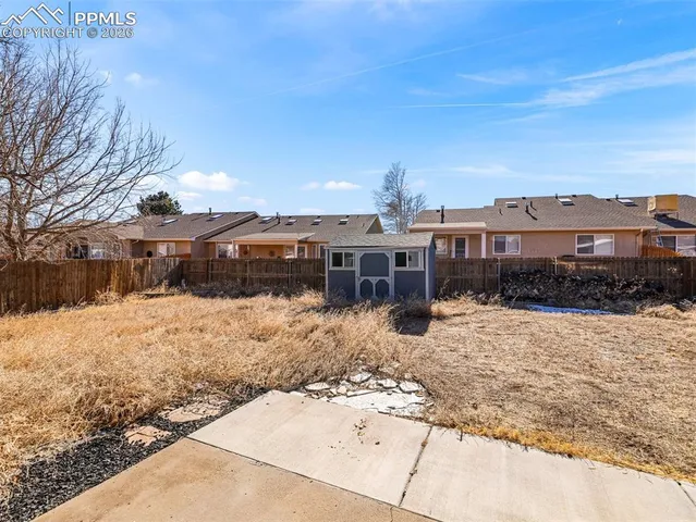 a view of a house with a yard covered in snow