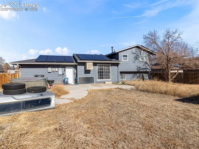 a front view of a house with a yard and balcony