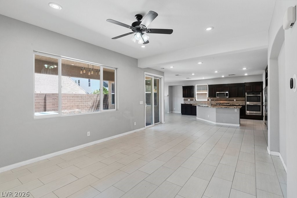 10336 Hawk Ravine Street Las Vegas, NV 89178 - Photo 5 of 59 Bright and open, this modern space flows seamlessly from living to kitchen.