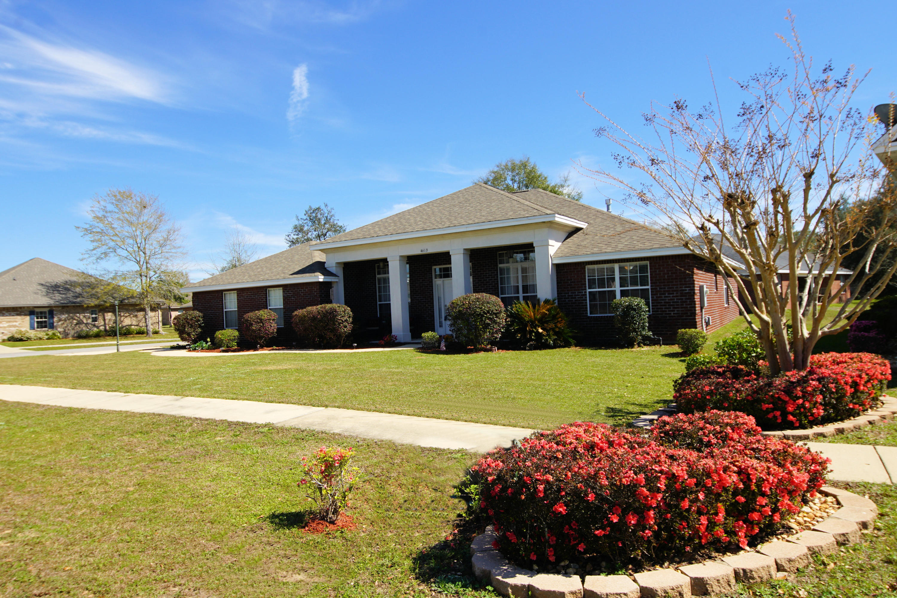 4613 Chanan Drive Crestview, FL 32539 - Photo 1 of 44 a front view of a house with garden