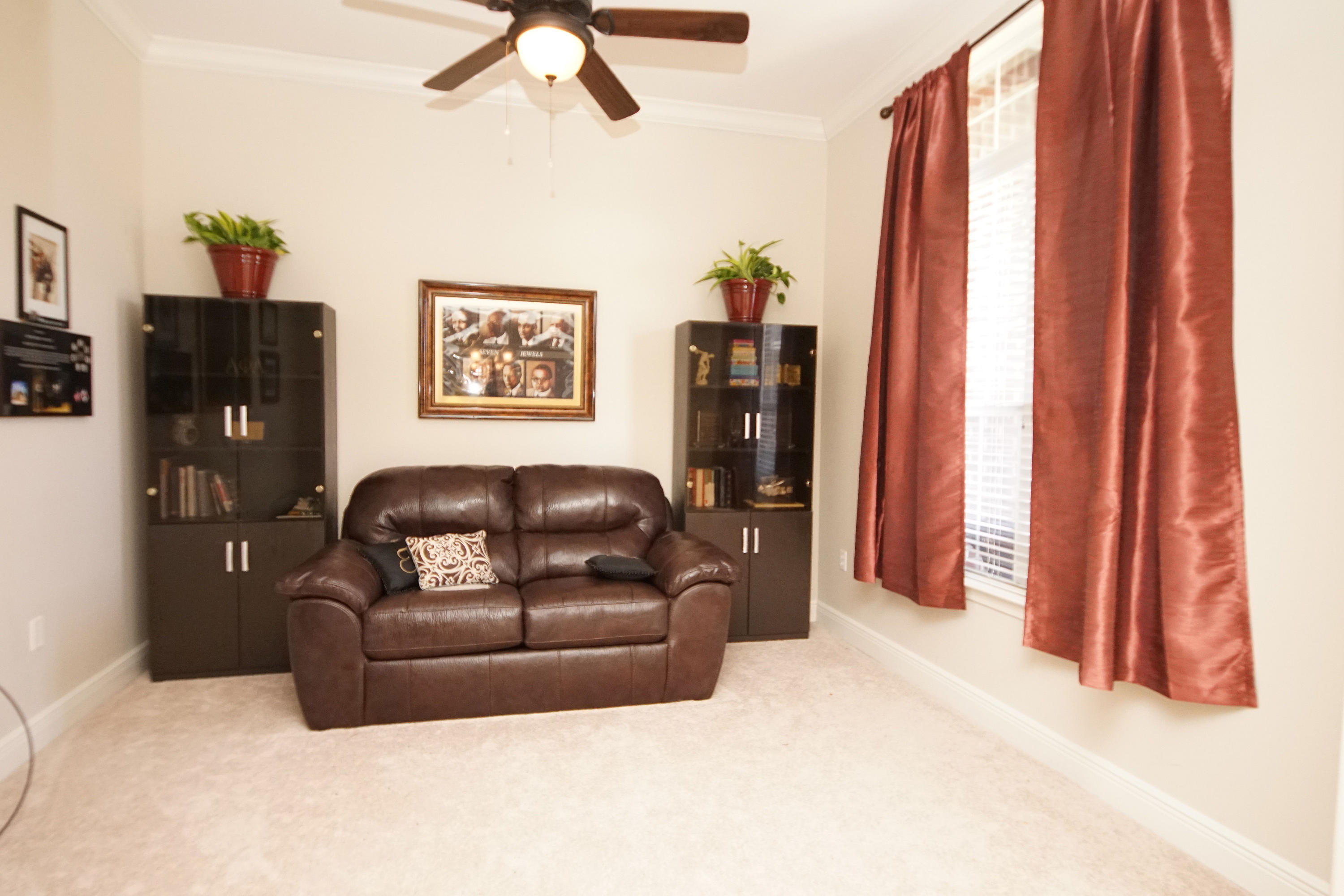 4613 Chanan Drive Crestview, FL 32539 - Photo 13 of 44 a living room with furniture and a flat screen tv