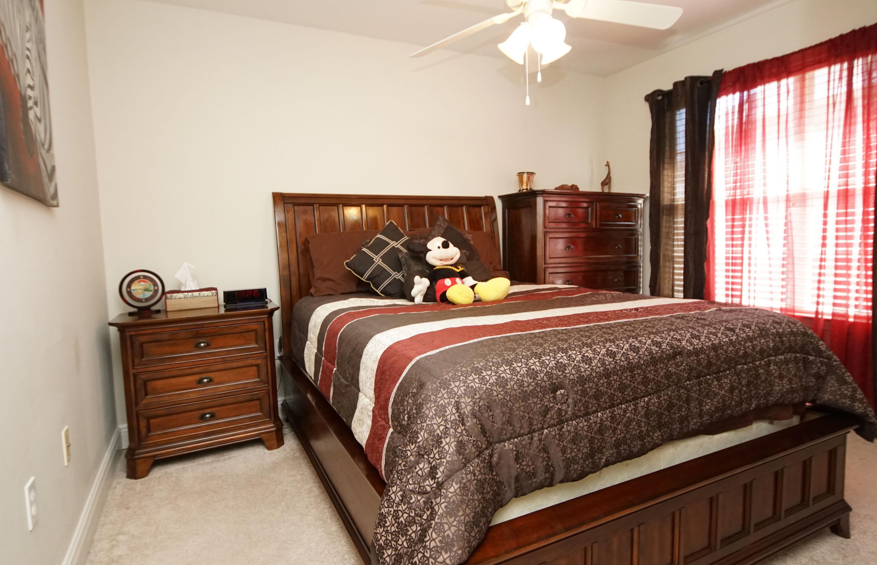 4613 Chanan Drive Crestview, FL 32539 - Photo 21 of 44 a bedroom with a bed and a chandelier