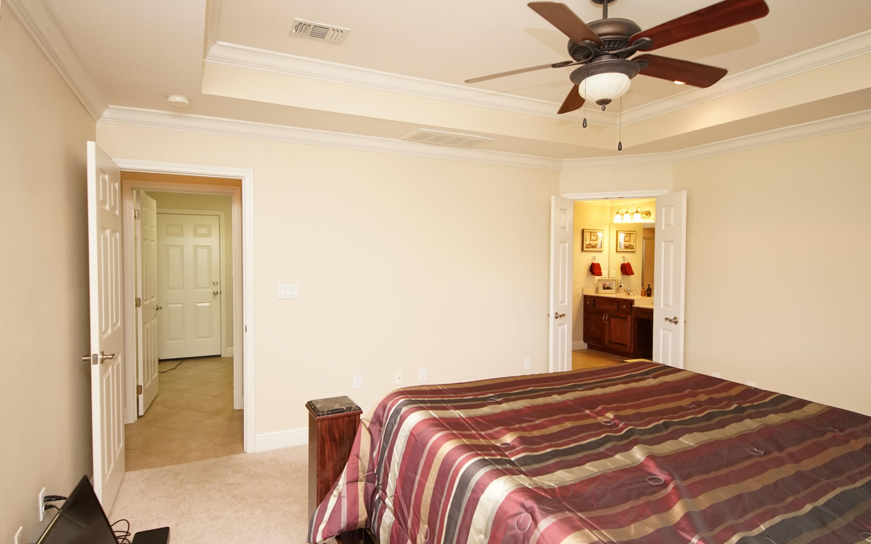 4613 Chanan Drive Crestview, FL 32539 - Photo 26 of 44 a bedroom with a bed and a chandelier