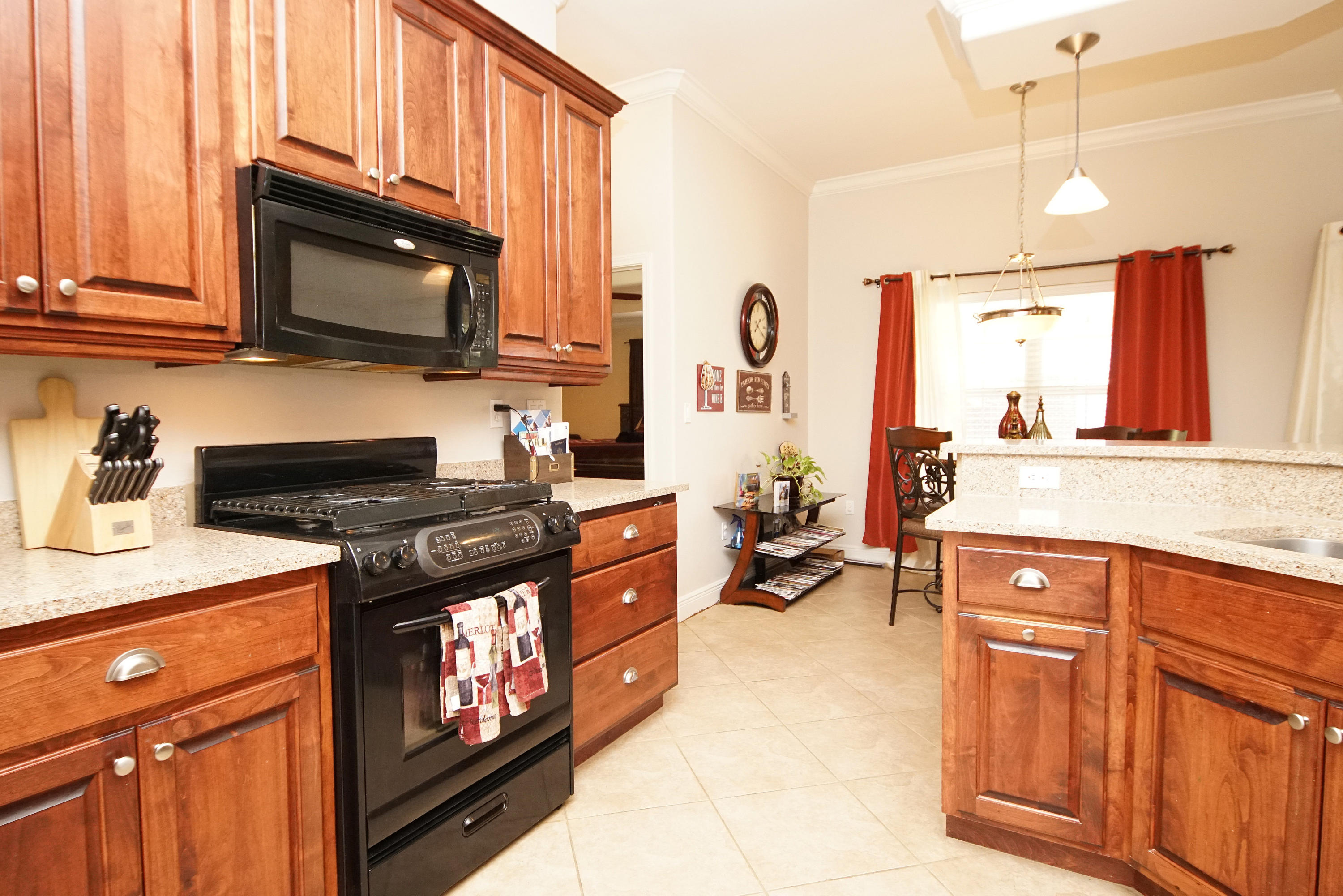 4613 Chanan Drive Crestview, FL 32539 - Photo 27 of 44 a kitchen with stainless steel appliances granite countertop a stove a sink and a microwave