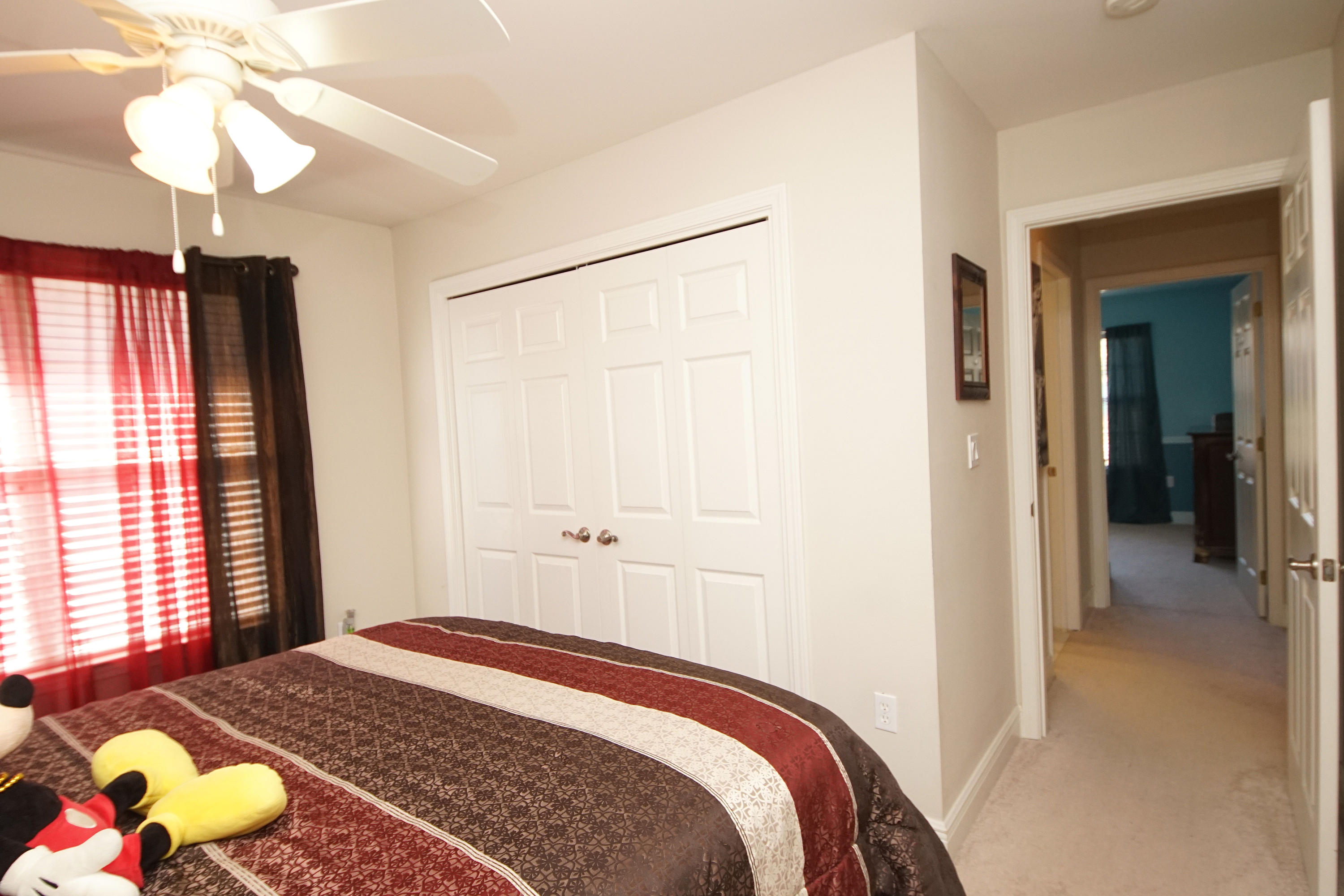 4613 Chanan Drive Crestview, FL 32539 - Photo 29 of 44 a bedroom with a bed and a chandelier