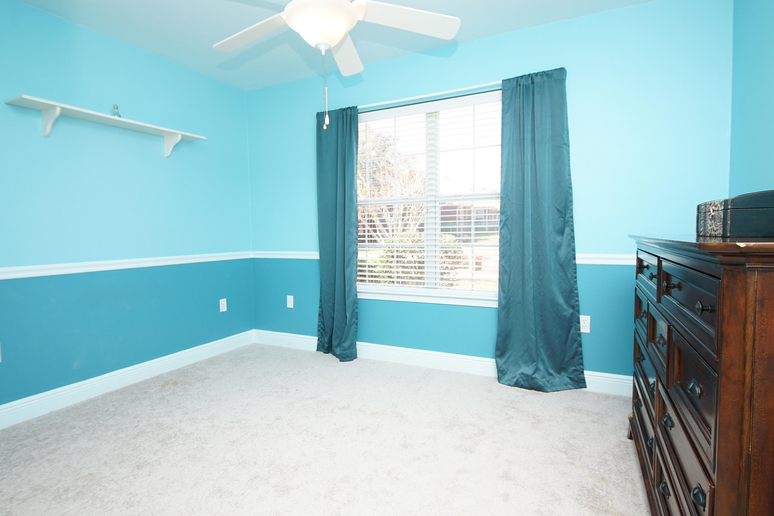 4613 Chanan Drive Crestview, FL 32539 - Photo 30 of 44 a view of an empty room with a window and a kitchen