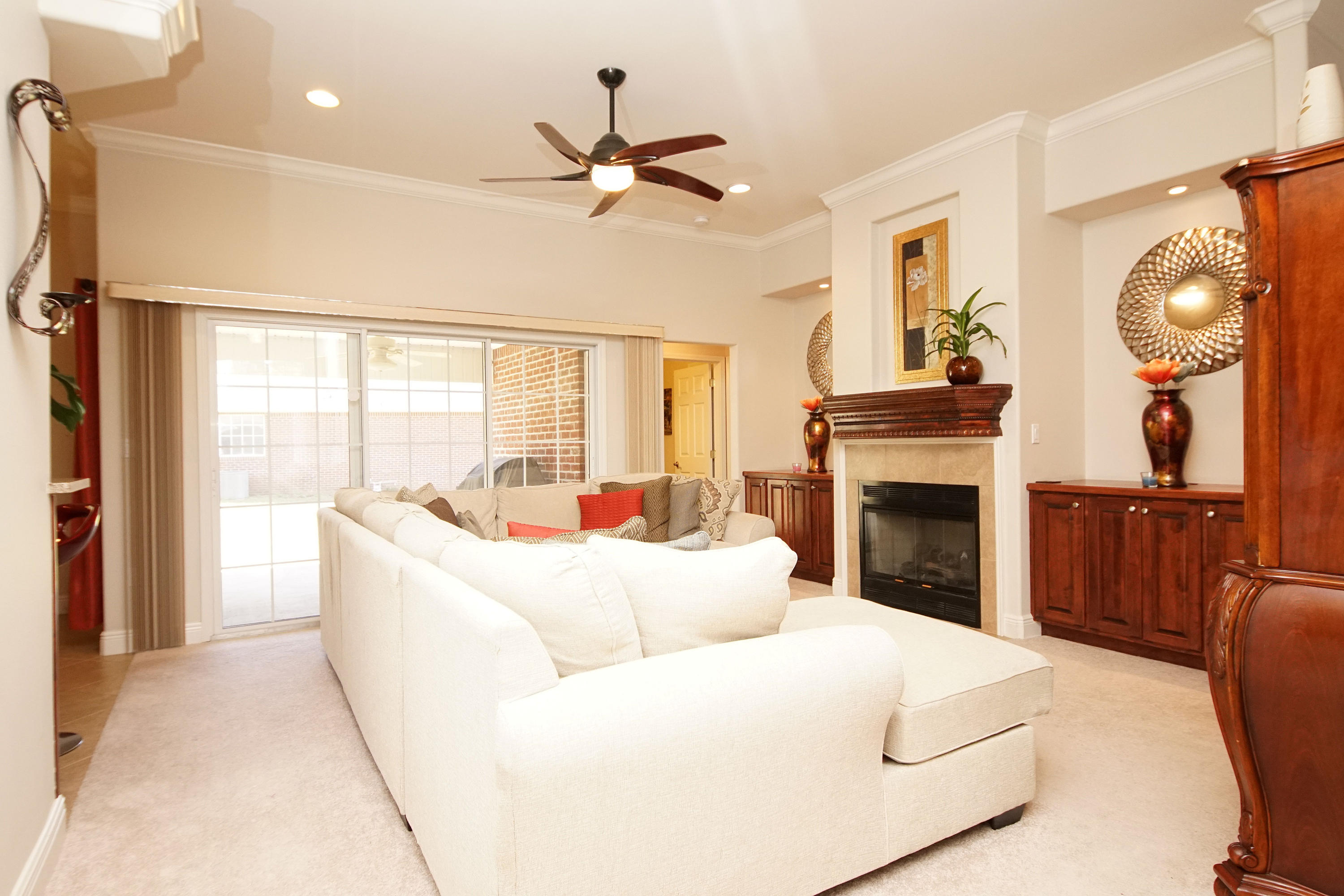 4613 Chanan Drive Crestview, FL 32539 - Photo 35 of 44 a living room with furniture a fireplace and a large window