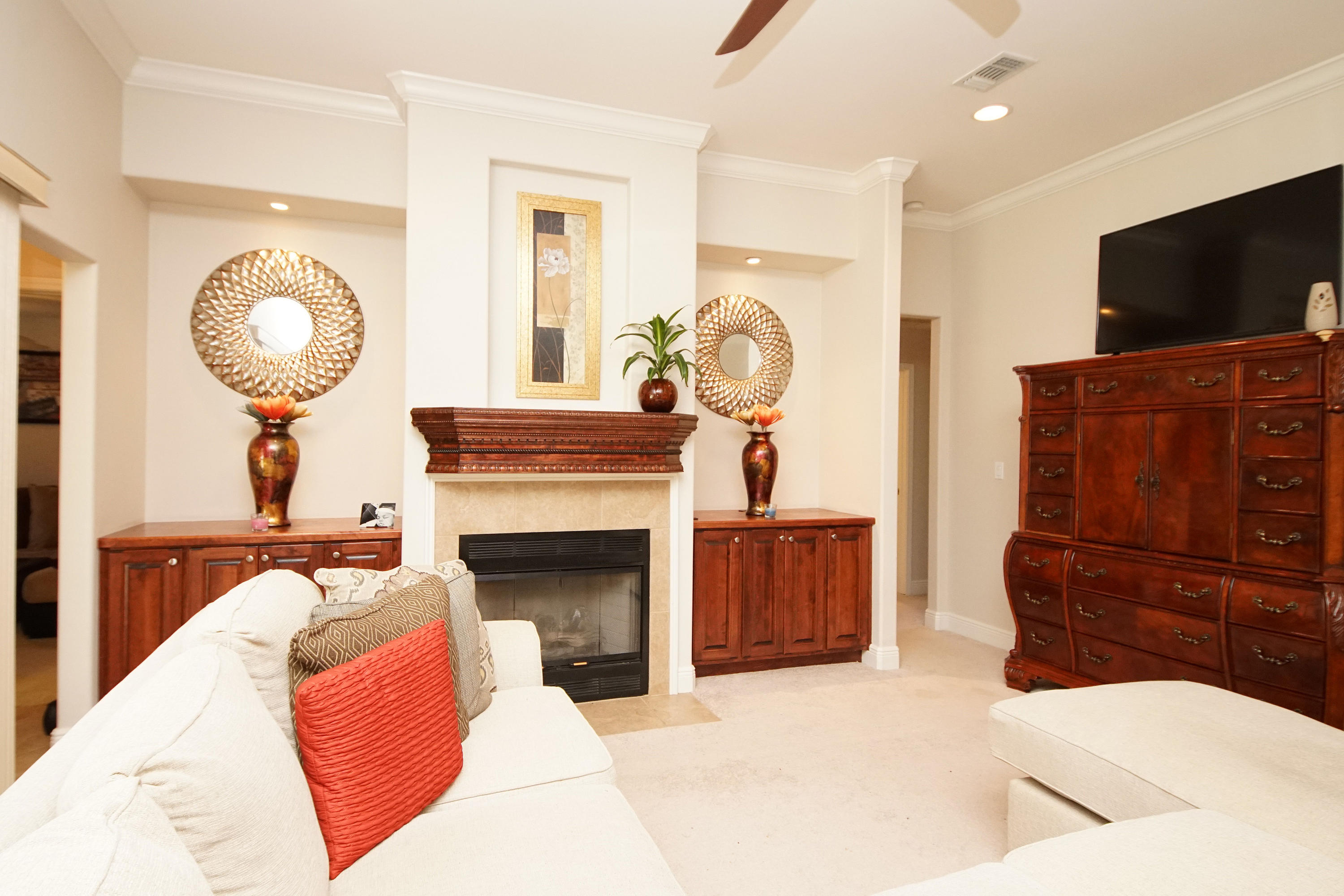 4613 Chanan Drive Crestview, FL 32539 - Photo 10 of 44 a living room with furniture a flat screen tv and a fireplace