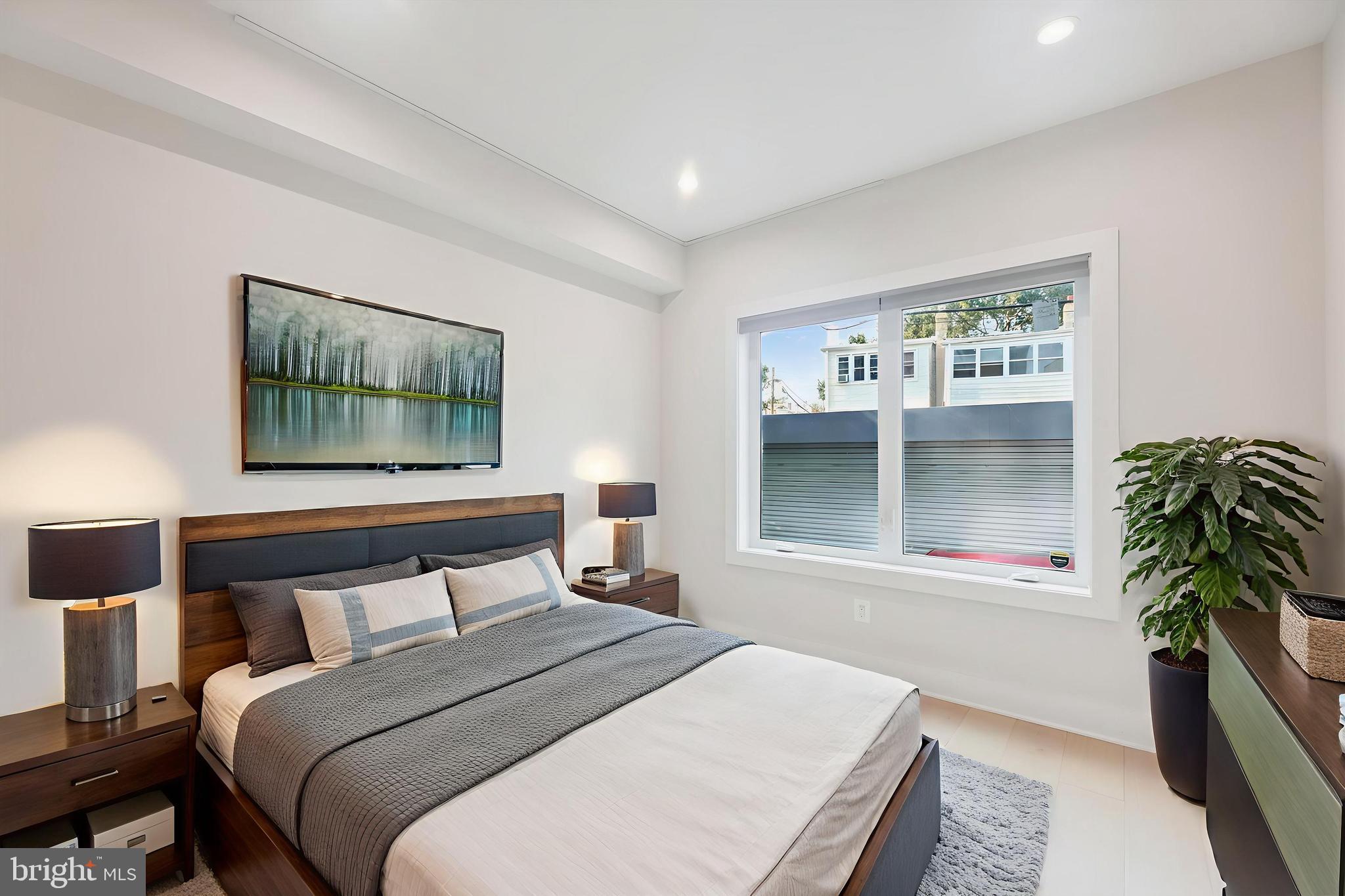 1910 Benning Road Northeast, Unit 2 Washington, DC 20002 - Photo 13 of 19 a bedroom with a bed and a large window
