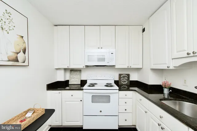 a kitchen with a refrigerator and cabinets