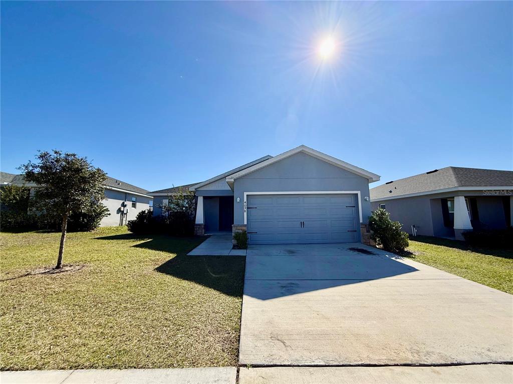 4098 Ruby Run Haines City, FL 33844 - Photo 2 of 34 a view of a house with a yard