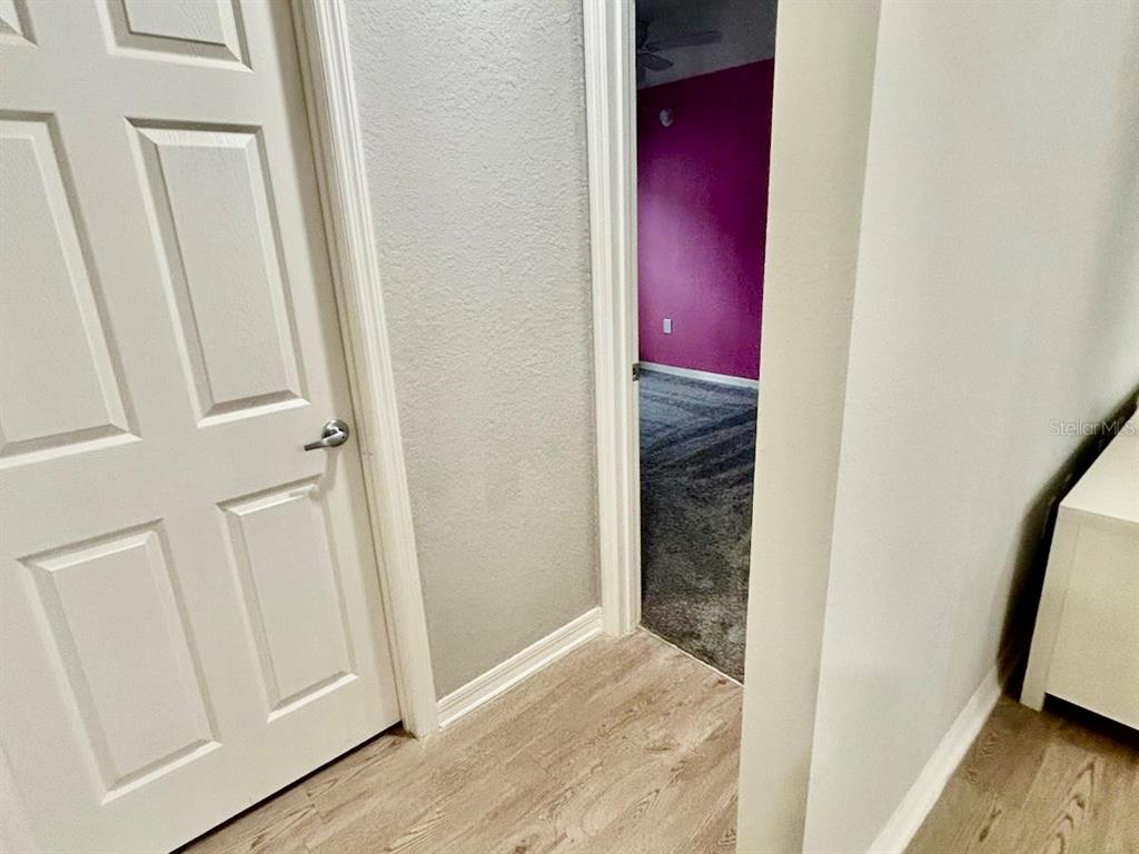 4098 Ruby Run Haines City, FL 33844 - Photo 23 of 34 a view of a hallway with wooden floor