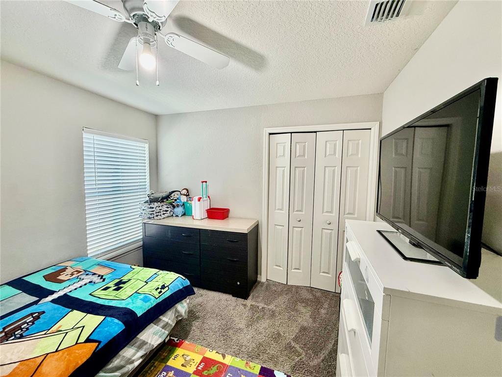 4098 Ruby Run Haines City, FL 33844 - Photo 28 of 34 a bedroom with a bed and a window