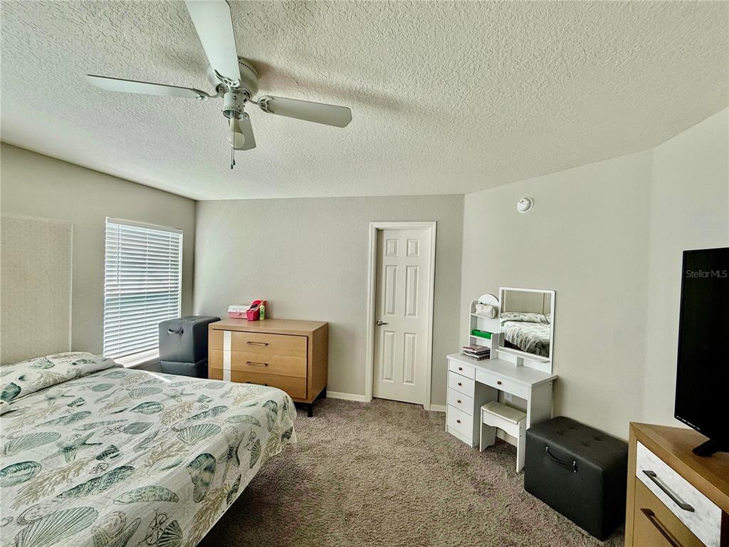 4098 Ruby Run Haines City, FL 33844 - Photo 29 of 34 a bedroom with a bed and a flat screen tv