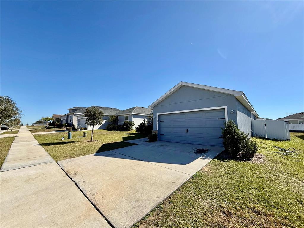 4098 Ruby Run Haines City, FL 33844 - Photo 3 of 34 a view of a house with a yard