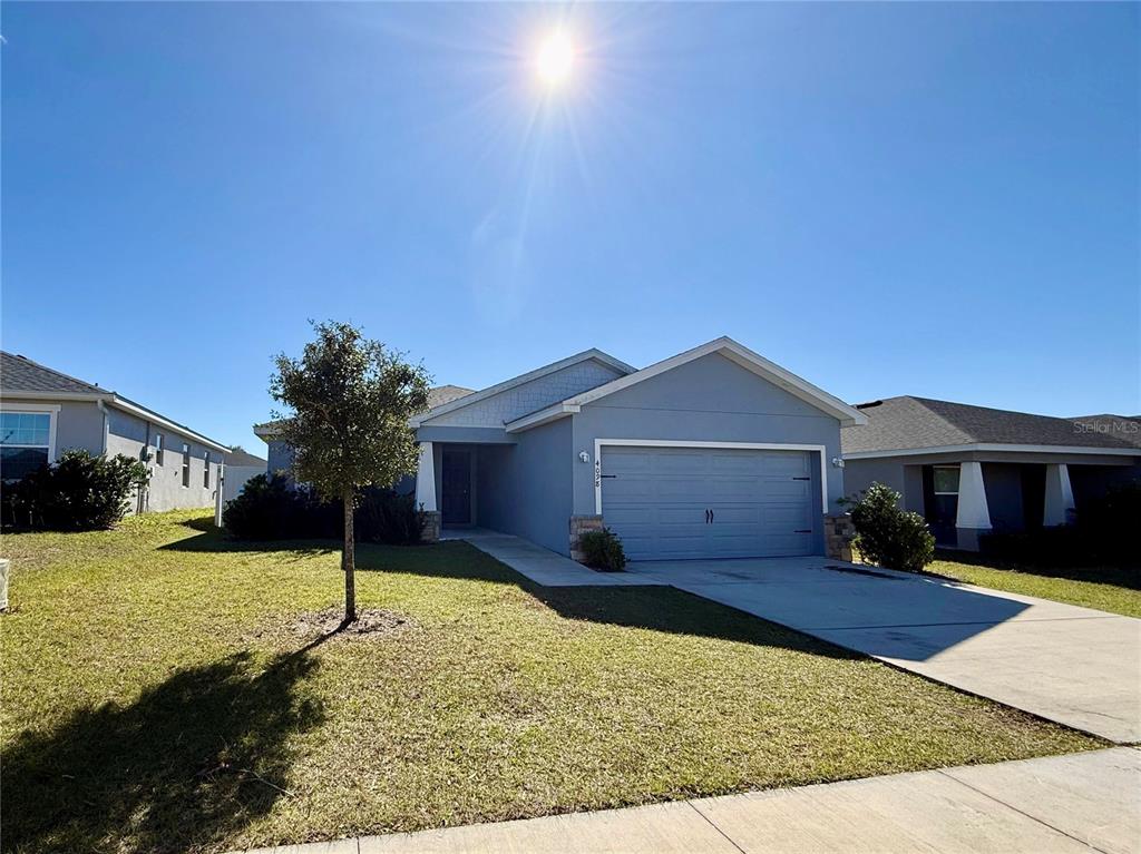 4098 Ruby Run Haines City, FL 33844 - Photo 5 of 34 a view of a house with a yard