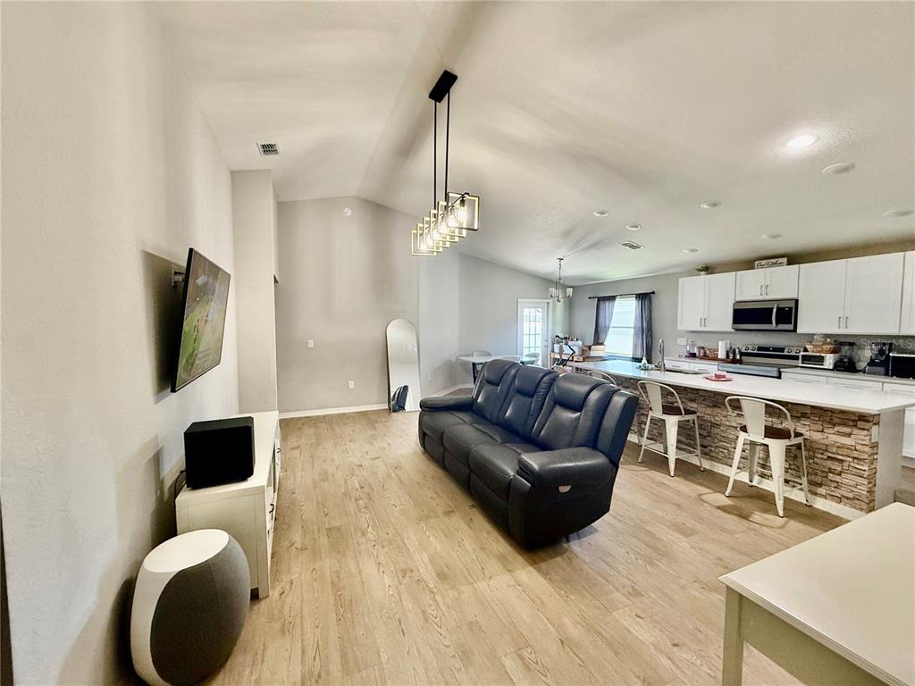 4098 Ruby Run Haines City, FL 33844 - Photo 10 of 34 a living room with furniture and a flat screen tv