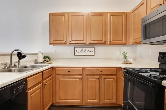 a kitchen with stainless steel appliances granite countertop a sink stove and microwave