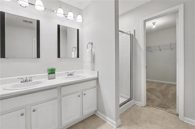 a bathroom with double sink and a mirror