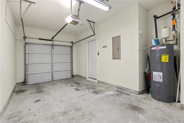 a view of a house with a large window and wooden fence