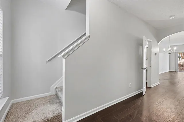 a view of hallway with stairs and wooden floor