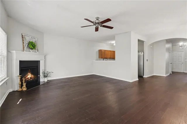 a view of an empty room with a fireplace and a window